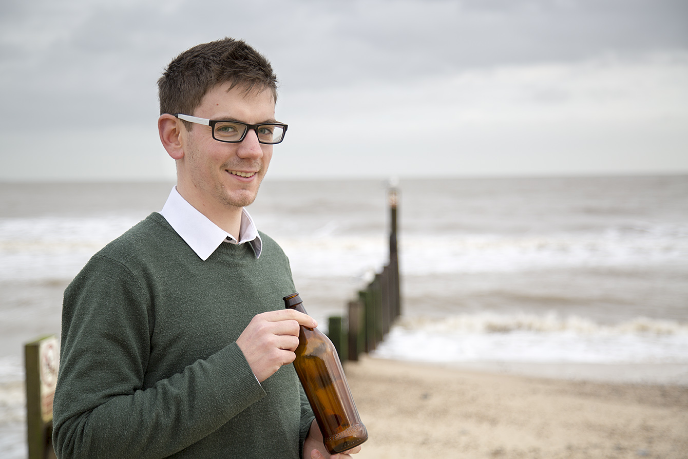 Sustainability Manager Ben Orchard, with the lighter weight brown glass bottle